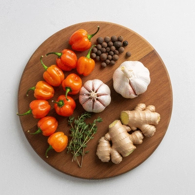Assortment of fresh jerk marinade ingredients on a wooden board