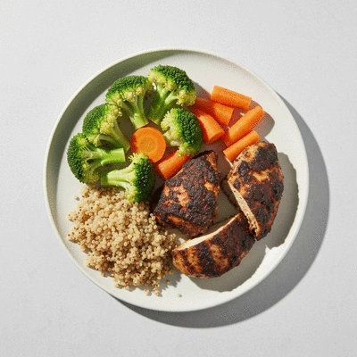 Variety of healthy side dishes like steamed vegetables and quinoa next to jerk chicken